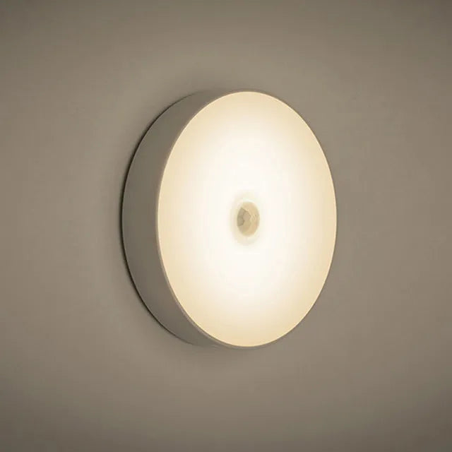 White USB rechargeable LED body induction night light with adhesive backing showing 86mm diameter
