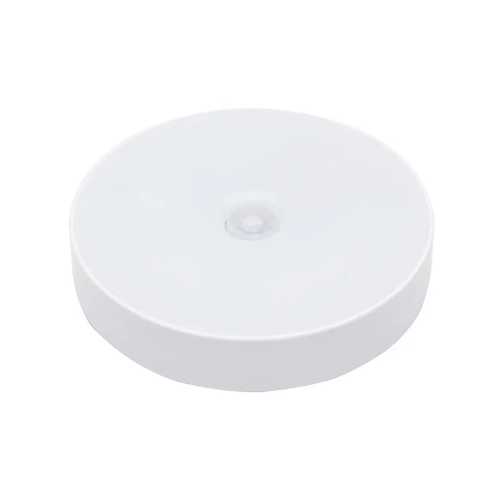 White USB rechargeable LED body induction night light with adhesive backing showing 86mm diameter