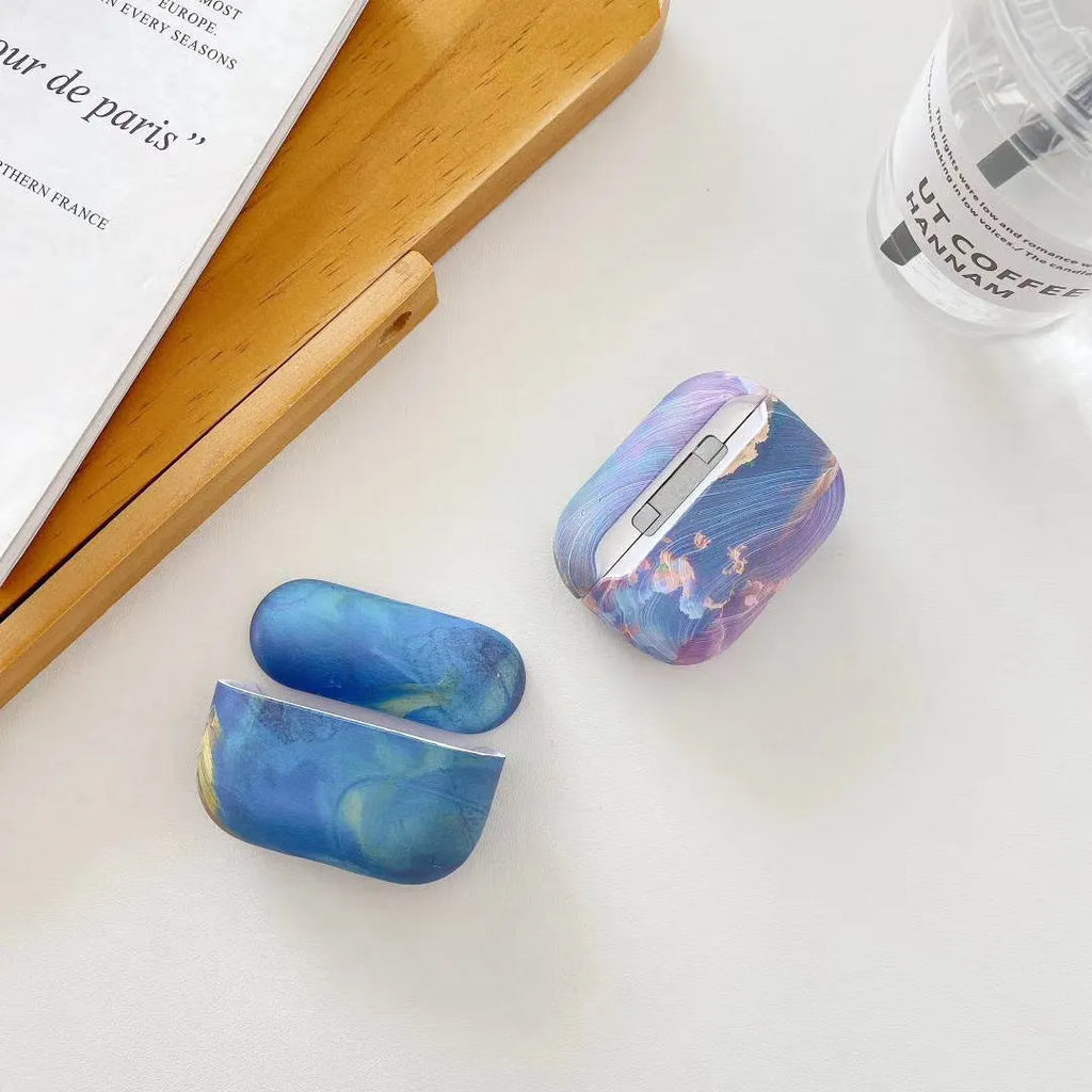 Hard plastic protective sleeve for Apple AirPods case in a blue watercolour design.