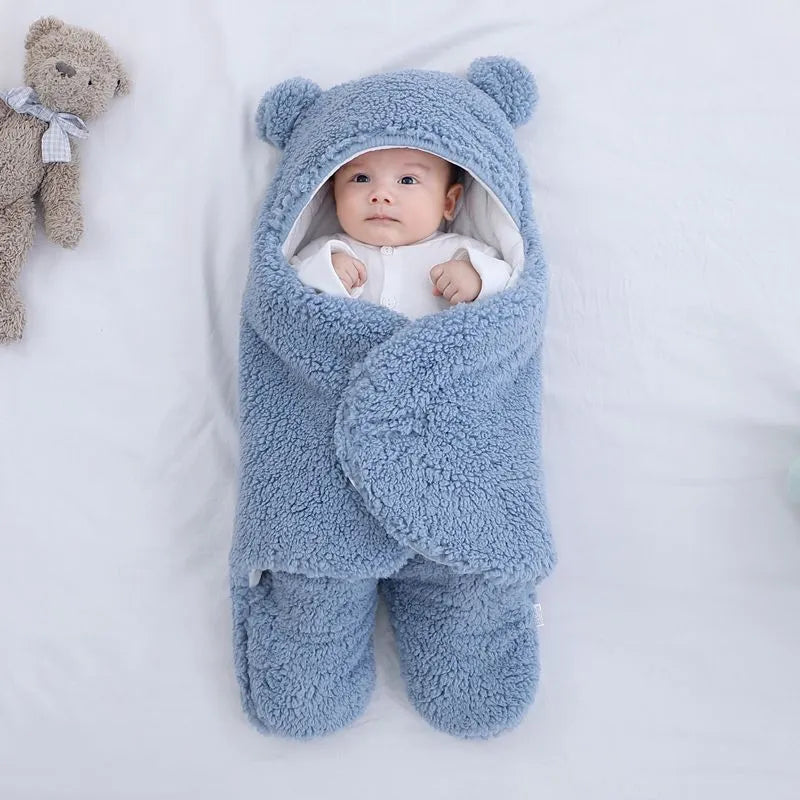 Cotton blend quilted baby sleeping bag wrapper in light blue, shown laid flat.