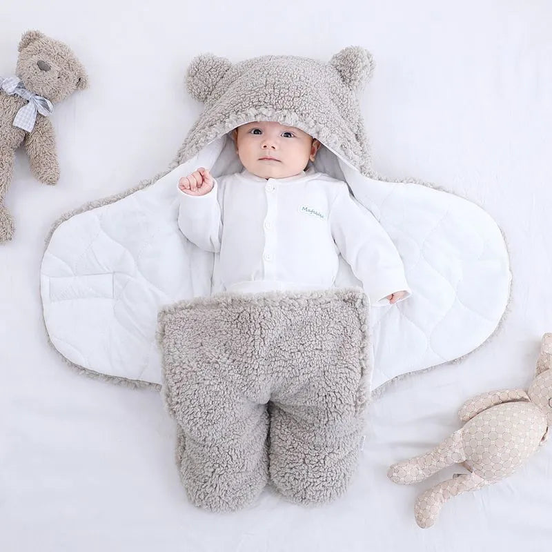 Cotton blend quilted baby sleeping bag wrapper in light blue, shown laid flat.