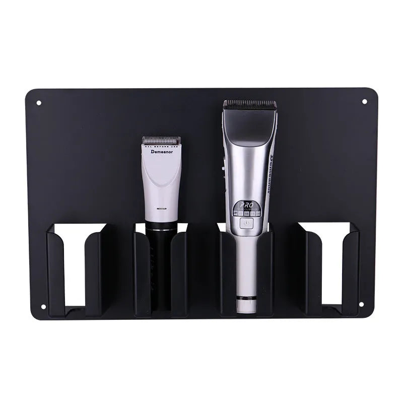 Black plastic wall-mounted frame holding four electric hair clippers.