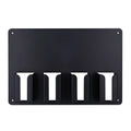 Black plastic wall-mounted frame holding four electric hair clippers.