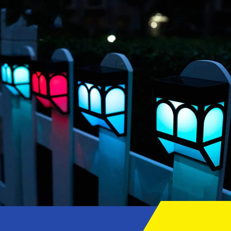 Square white solar-powered wall lamp mounted on an outdoor fence post.