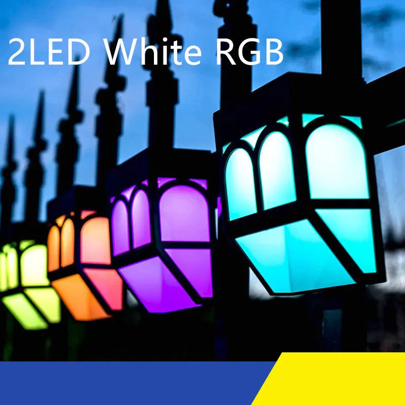 Square white solar-powered wall lamp mounted on an outdoor fence post.