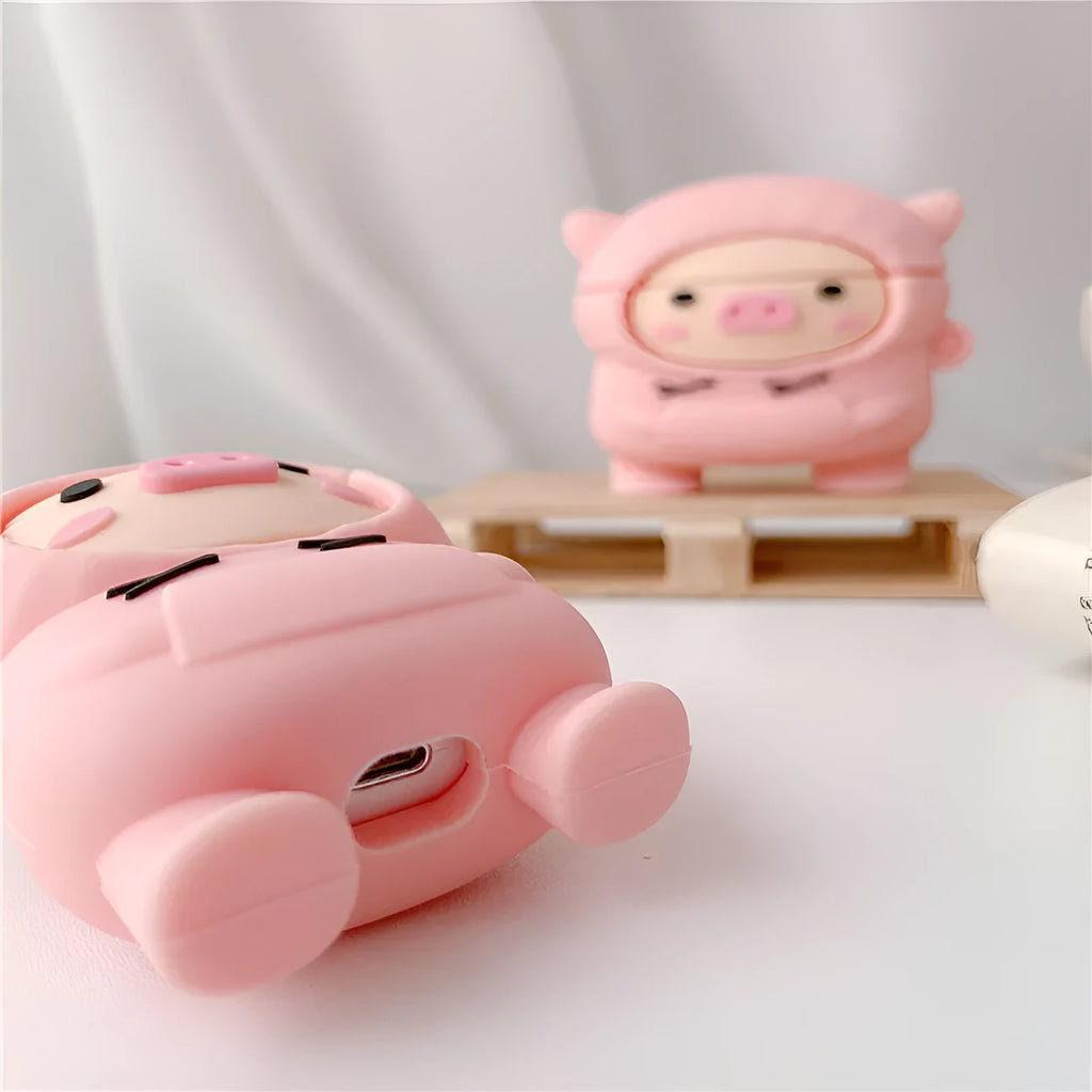 Pink silicone AirPods case with cartoon pig design and hook attachment