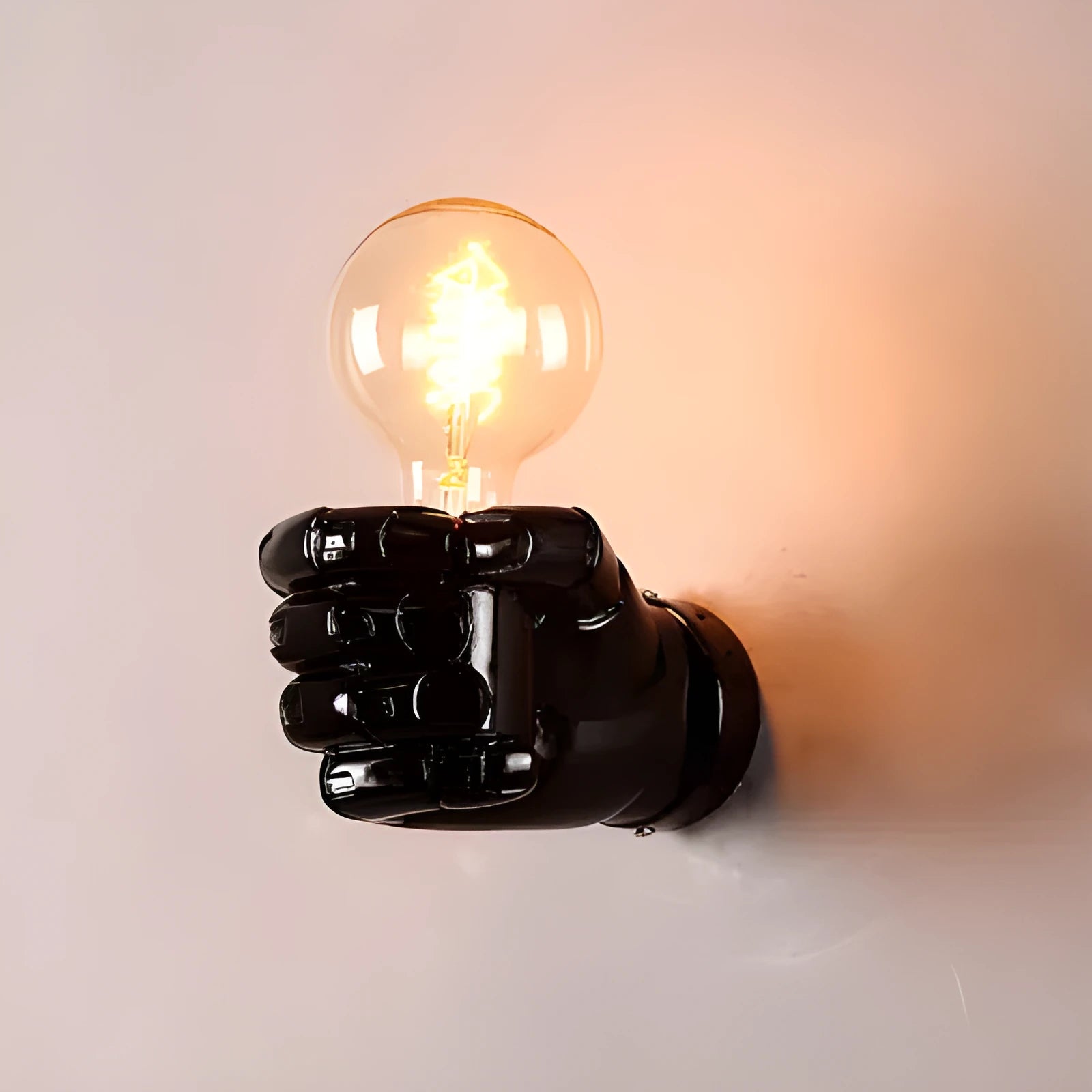 Sculptural resin fist wall lamp in black, white, or wood grain finish for decorative lighting.
