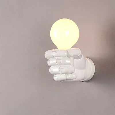 Sculptural resin fist wall lamp in black, white, or wood grain finish for decorative lighting.