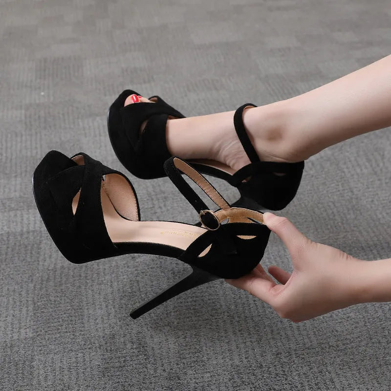 Black women's stiletto sandals with a fish mouth toe, low heel, and Roman style design.
