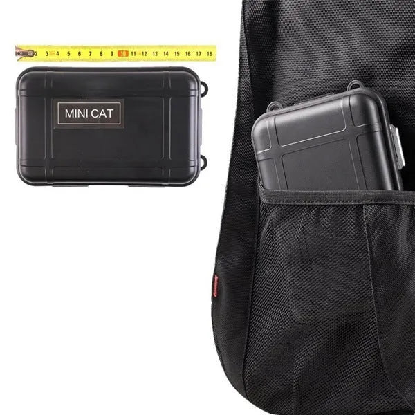 Black stainless steel survival treasure box open to show 13 emergency tools including flashlight, compass, and survival blanket