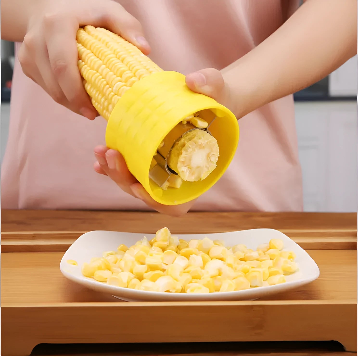 Yellow corn-shaped manual kitchen thresher for peeling corn kernels.