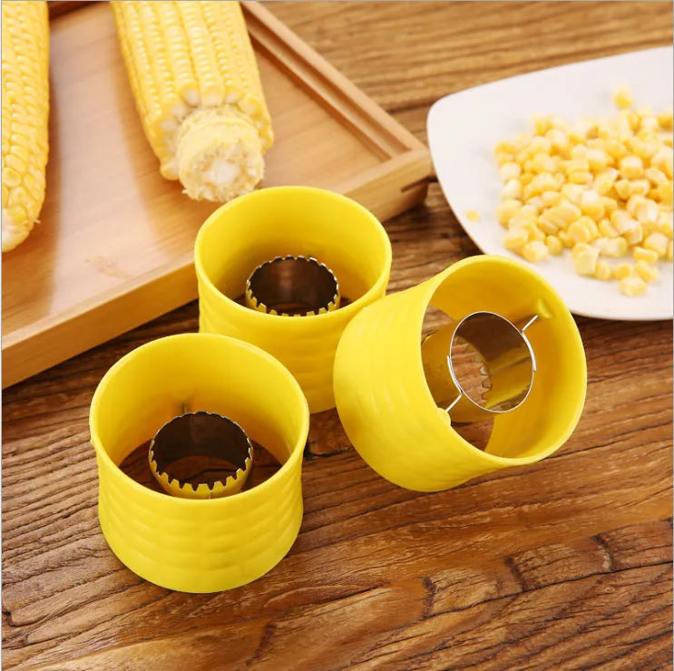 Yellow corn-shaped manual kitchen thresher for peeling corn kernels.