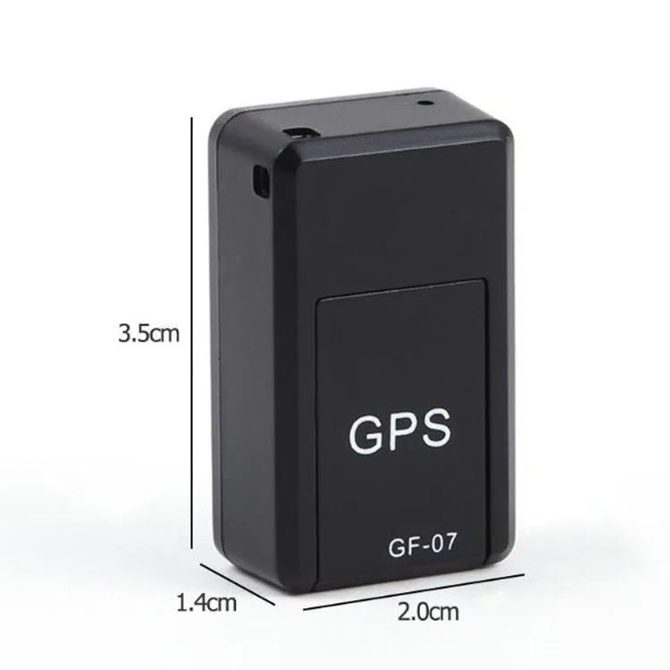 Small black plastic magnetic GPS car tracker device on a metal surface.
