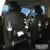 PU leather car storage bag hanging on seat back with multiple pockets and built-in trash can