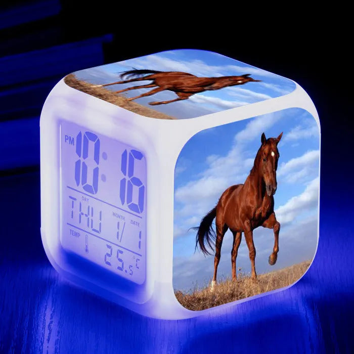 Small square plastic alarm clock with LED digital display showing time and temperature.