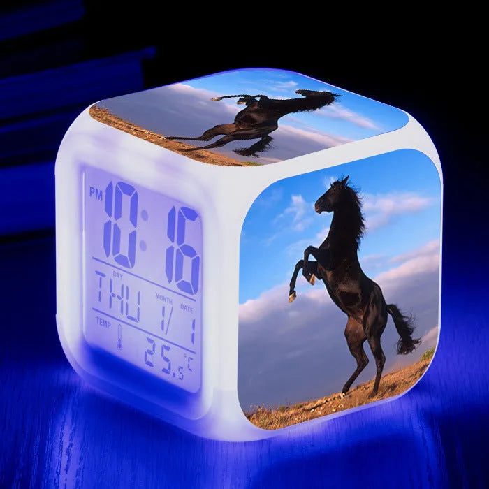 Small square plastic alarm clock with LED digital display showing time and temperature.