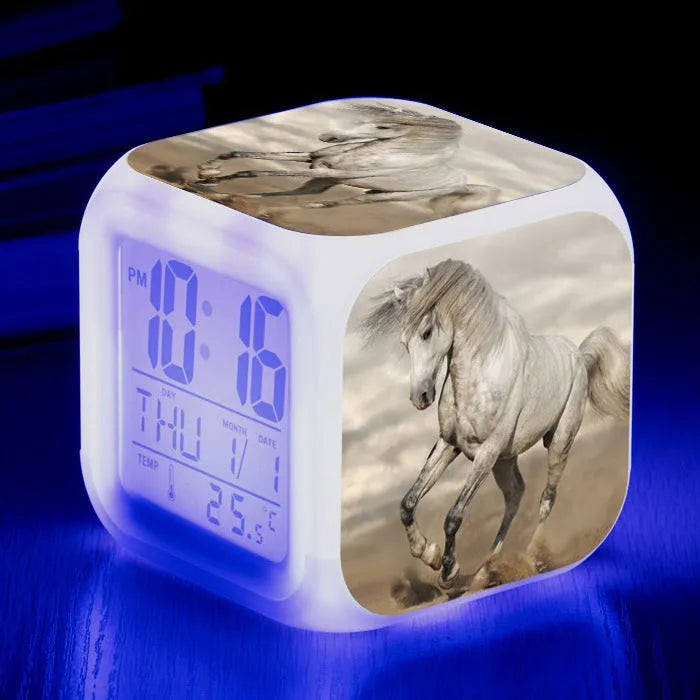 Small square plastic alarm clock with LED digital display showing time and temperature.