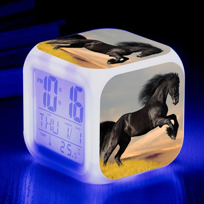 Small square plastic alarm clock with LED digital display showing time and temperature.