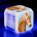 Small square plastic alarm clock with LED digital display showing time and temperature.