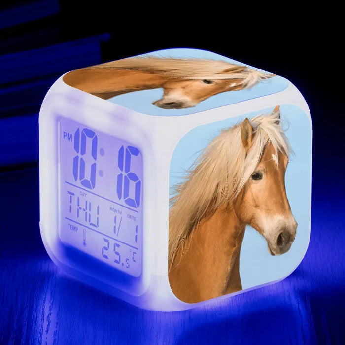 Small square plastic alarm clock with LED digital display showing time and temperature.