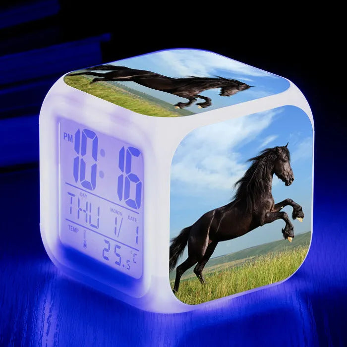 Small square plastic alarm clock with LED digital display showing time and temperature.