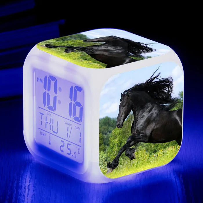 Small square plastic alarm clock with LED digital display showing time and temperature.