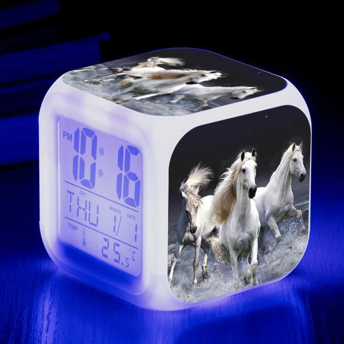 Small square plastic alarm clock with LED digital display showing time and temperature.