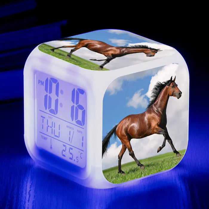 Small square plastic alarm clock with LED digital display showing time and temperature.