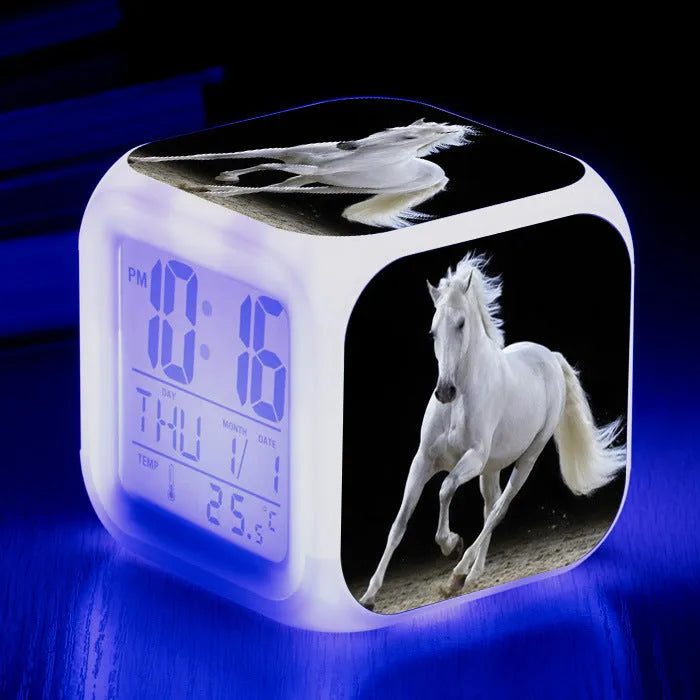 Small square plastic alarm clock with LED digital display showing time and temperature.