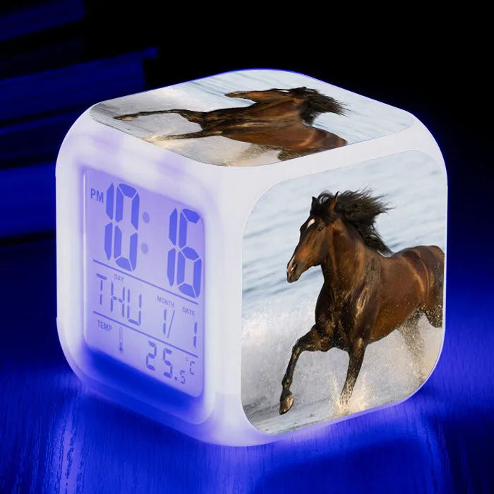 Small square plastic alarm clock with LED digital display showing time and temperature.