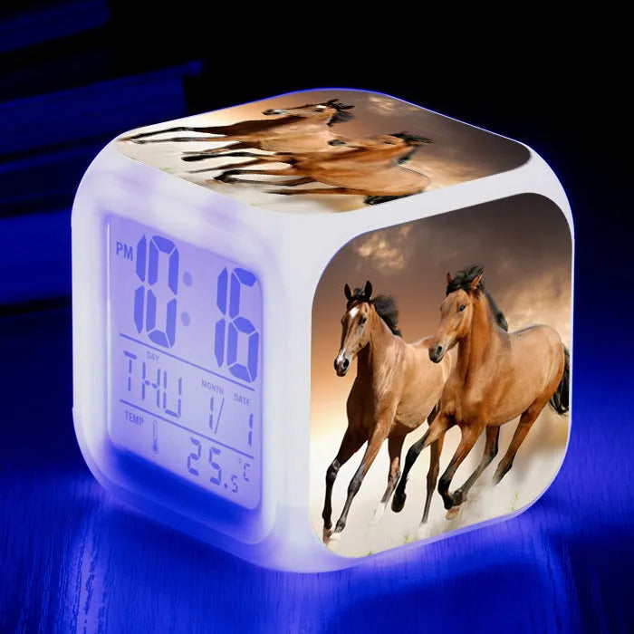 Small square plastic alarm clock with LED digital display showing time and temperature.