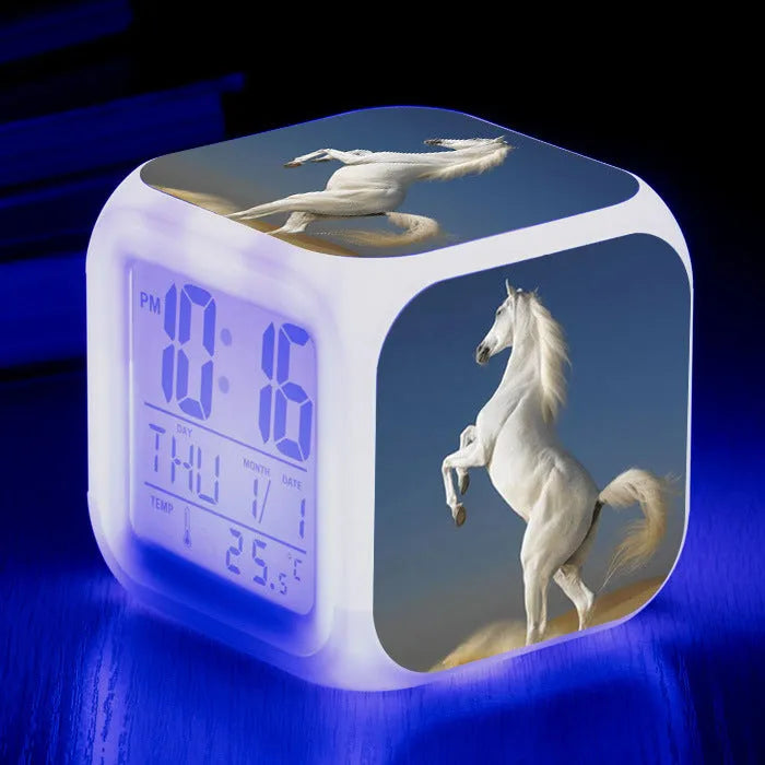 Small square plastic alarm clock with LED digital display showing time and temperature.