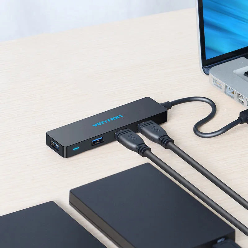 Black four-port USB 3.0 hub with 0.15 metre cable showing nickel-plated connectors