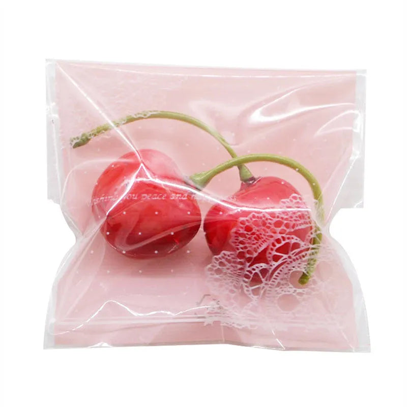 Pink self-adhesive plastic packaging bags with UV printed surface, shown in a pack.
