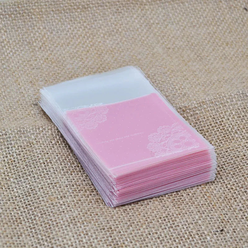 Pink self-adhesive plastic packaging bags with UV printed surface, shown in a pack.