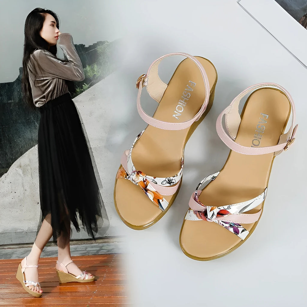 Women's pink wedge sandals with a thick heel, fish mouth design, and an adjustable buckle strap.