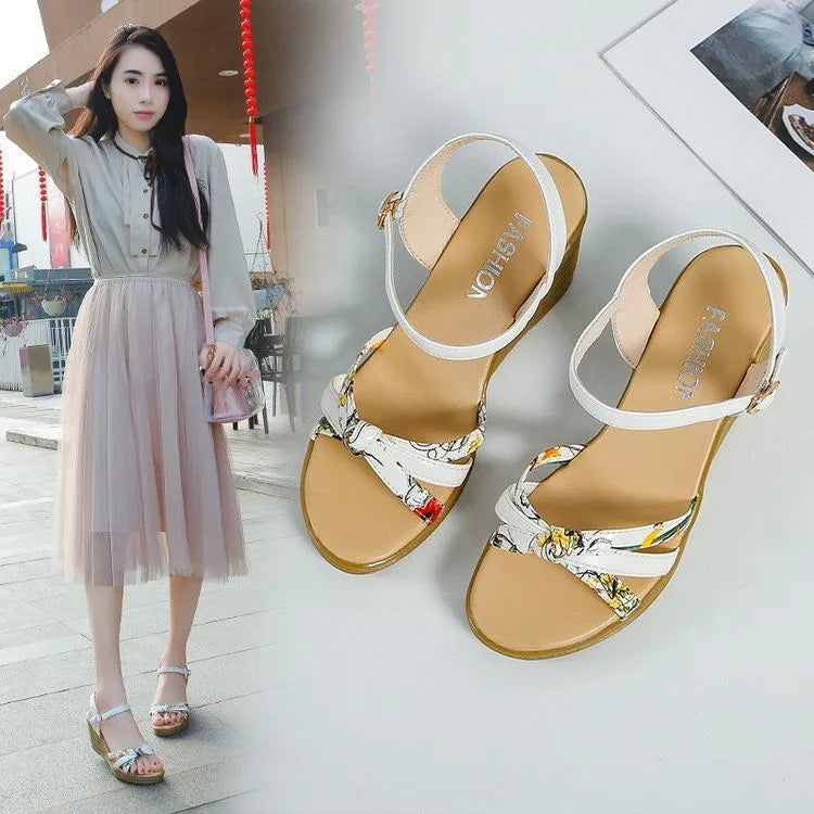Women's pink wedge sandals with a thick heel, fish mouth design, and an adjustable buckle strap.