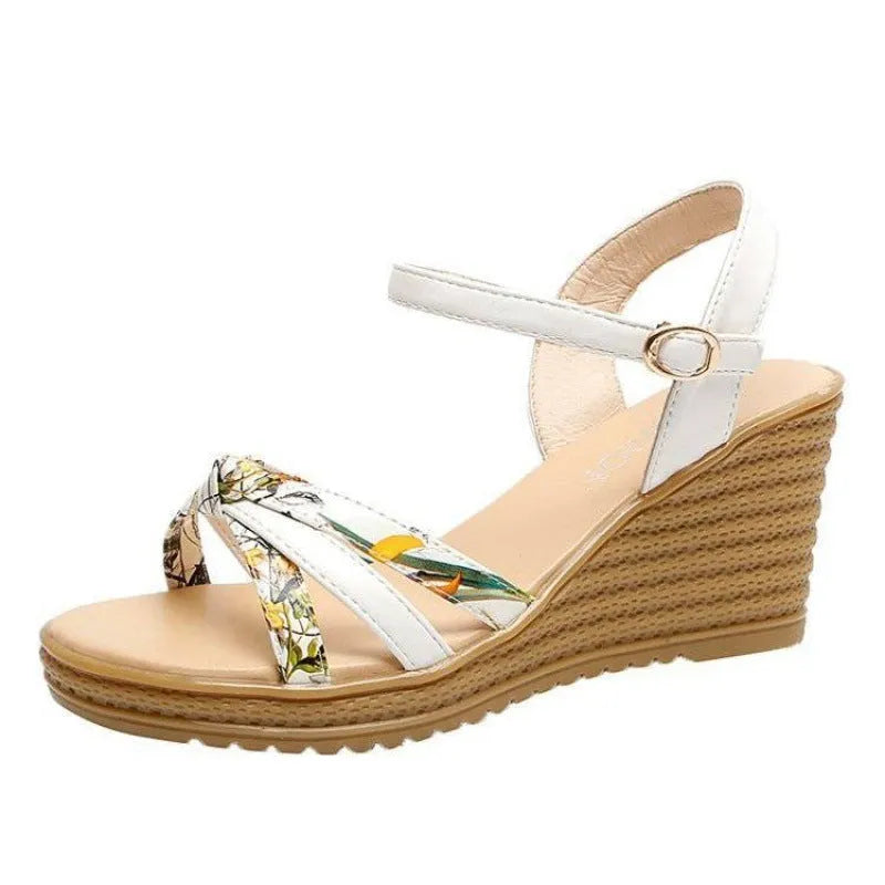 Women's pink wedge sandals with a thick heel, fish mouth design, and an adjustable buckle strap.