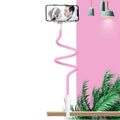Blue mobile phone holder with adjustable arm clamped to a bedside table