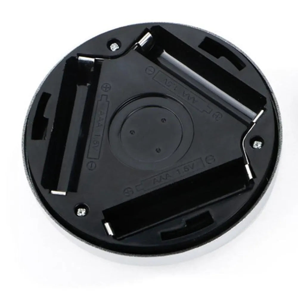Silver round wireless motion sensor LED night light with adhesive back.