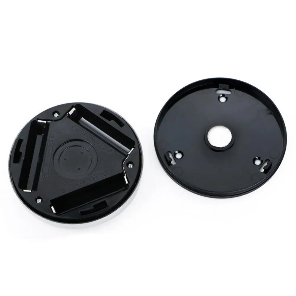 Silver round wireless motion sensor LED night light with adhesive back.
