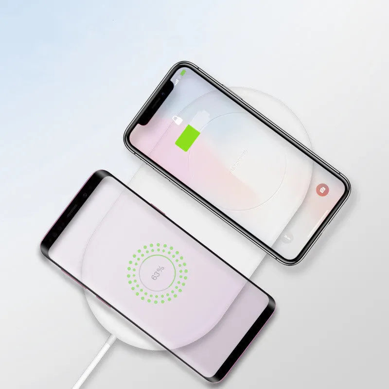 White dual mobile phone wireless charger charging two phones simultaneously
