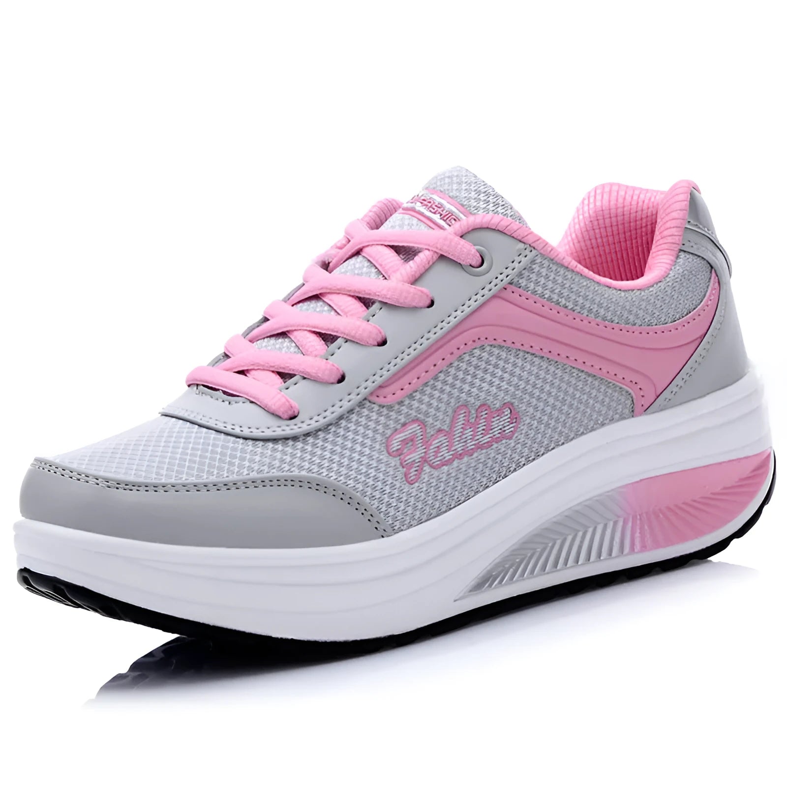 Women's grey pink heelless sports travel shoes with a mid heel on a neutral background.