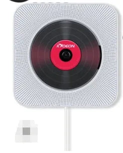 Wall-mounted CD player in white ABS plastic with remote control and power adapter.