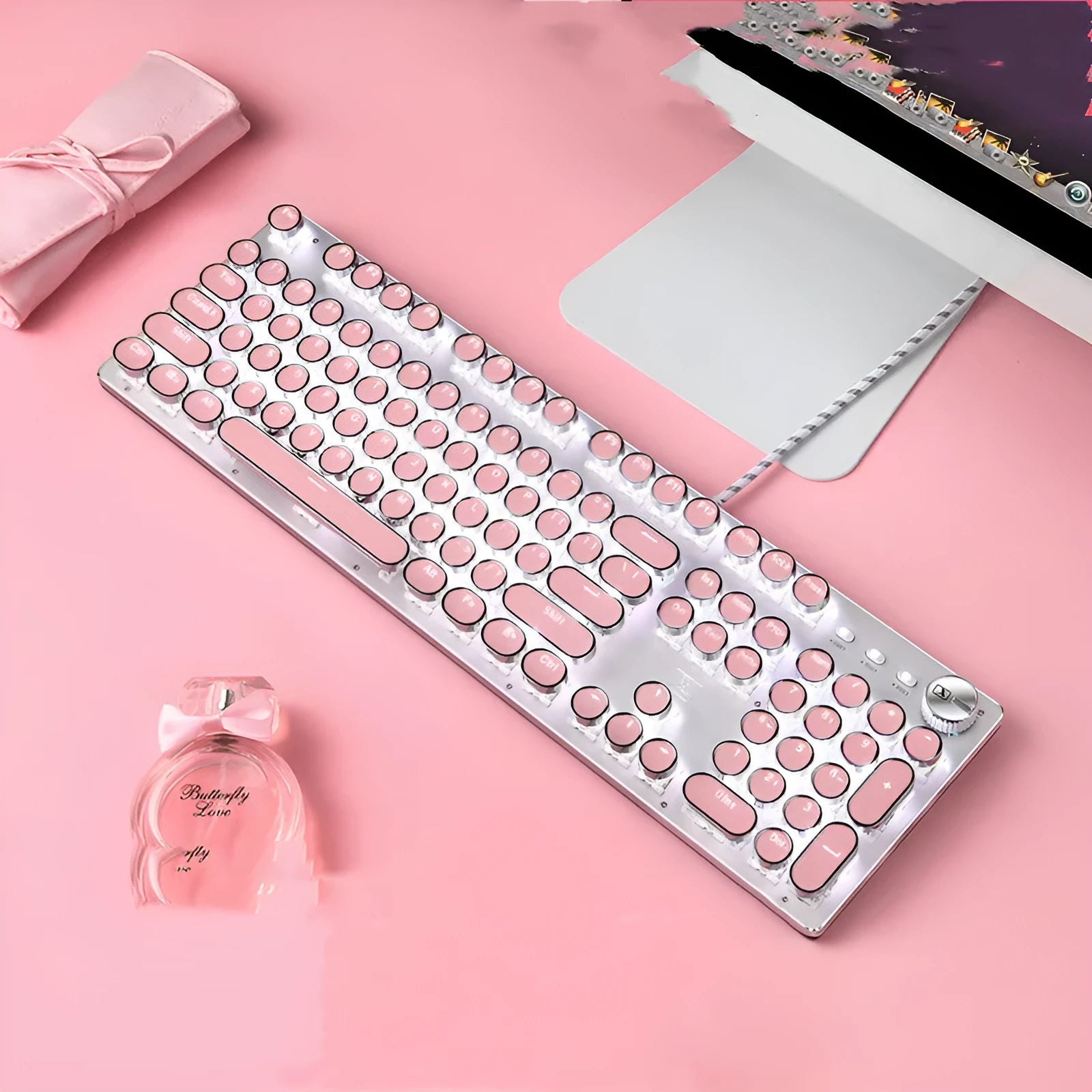 Silver and pink wired mechanical keyboard with round keycaps and white LED backlighting