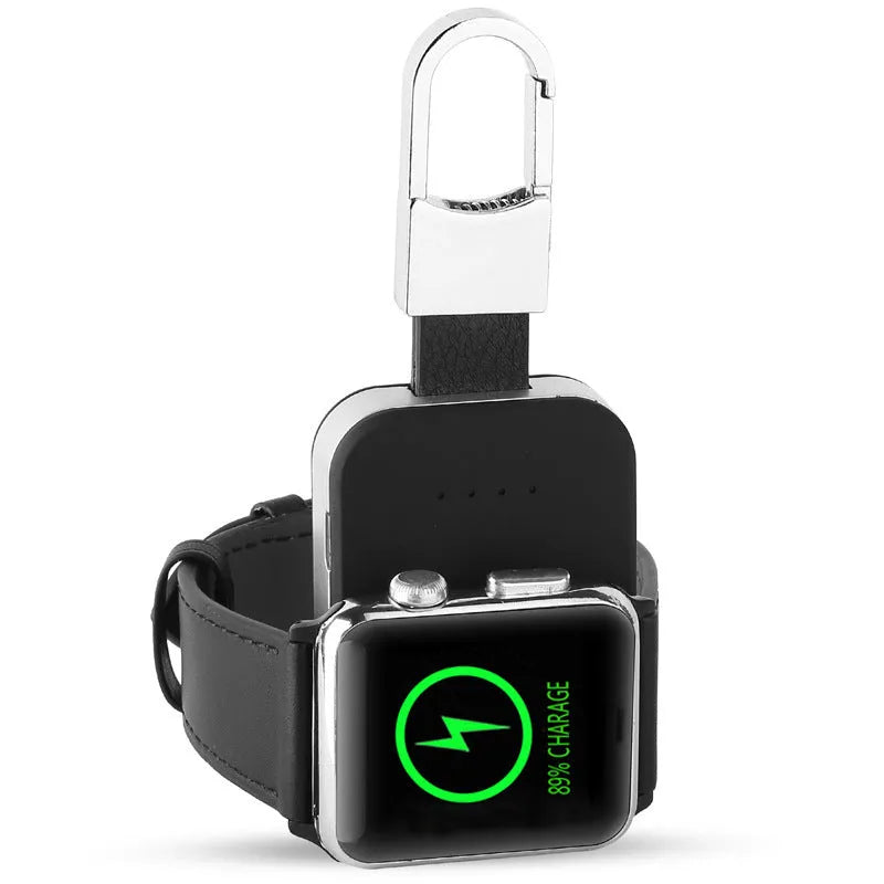 Black Apple Watch portable power bank keychain charger with USB port shown next to an Apple Watch.