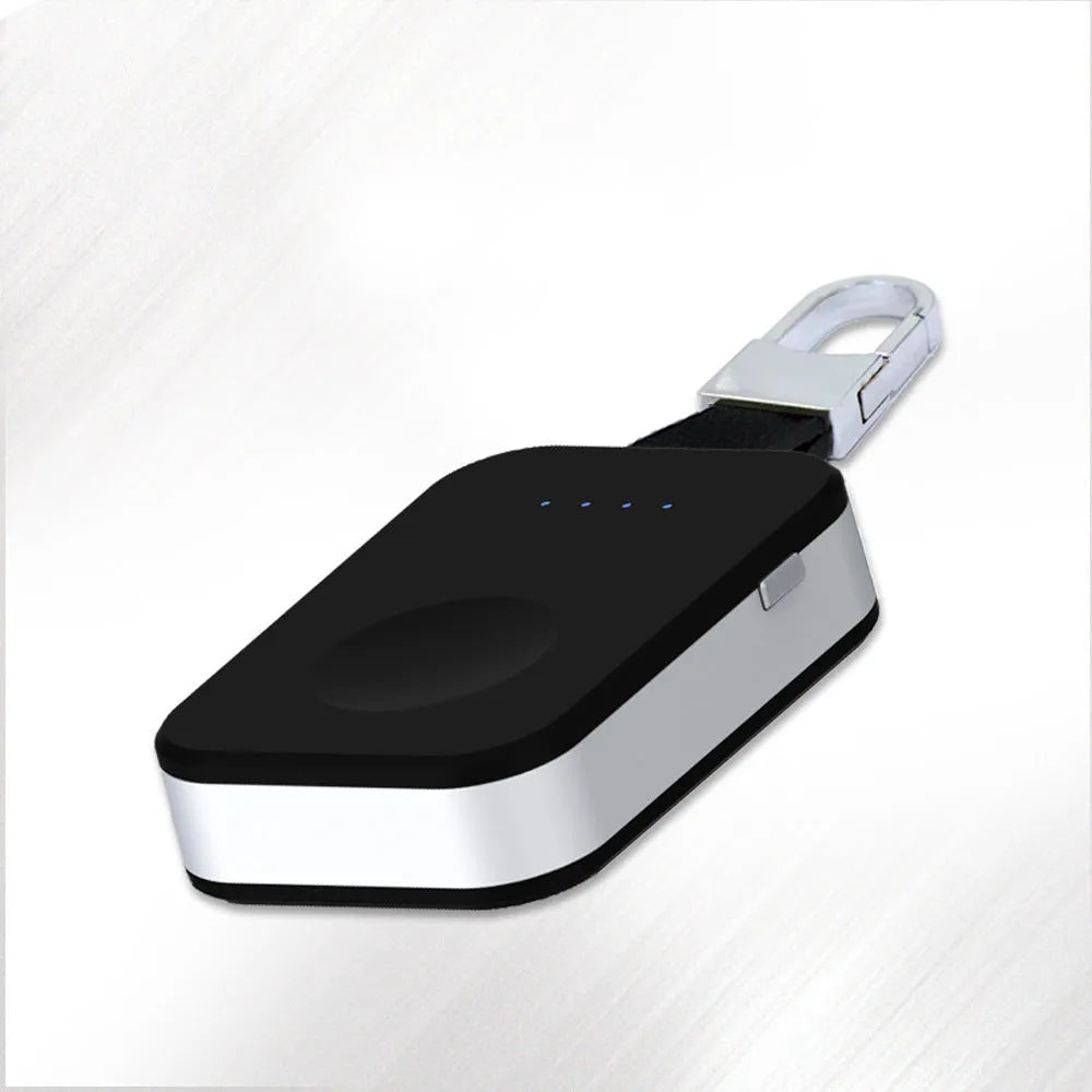 Black Apple Watch portable power bank keychain charger with USB port shown next to an Apple Watch.