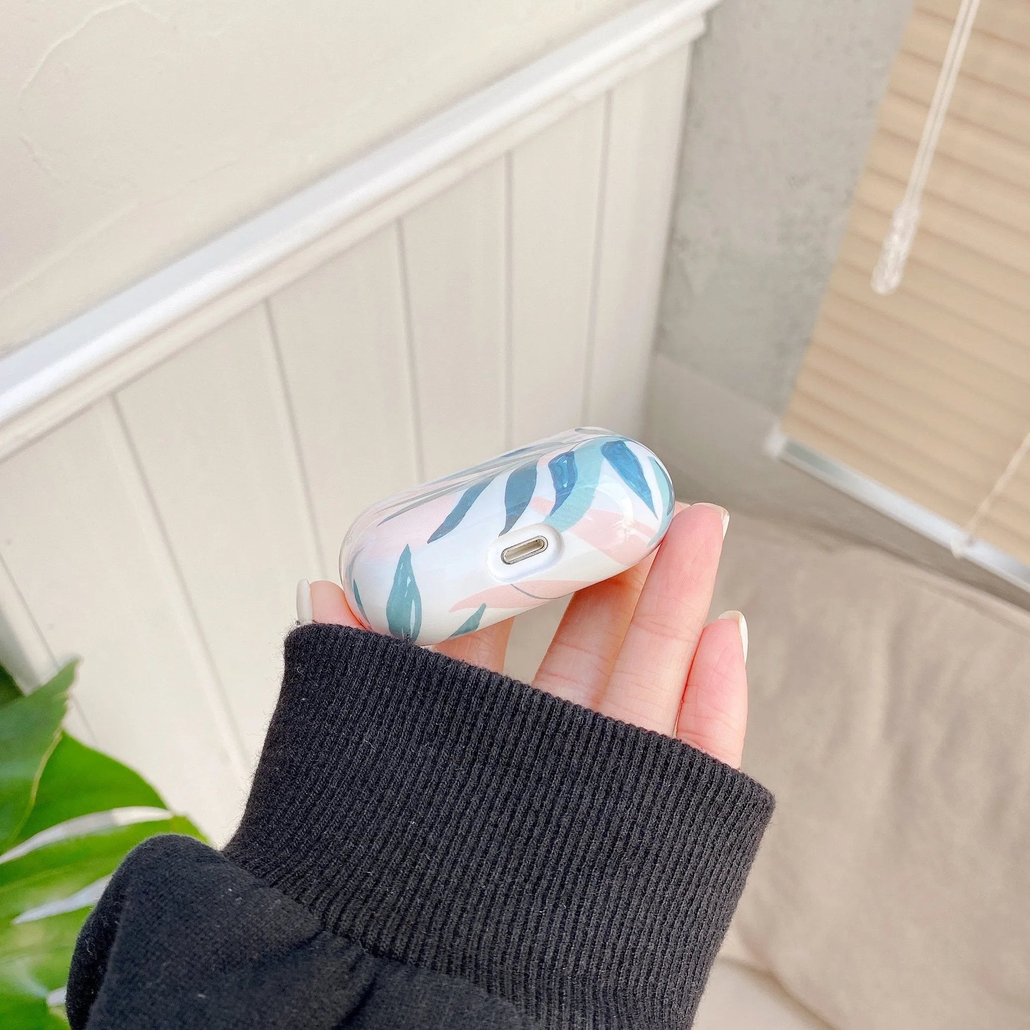 Blue and green banana leaves design soft TPU protective case for Apple AirPods.