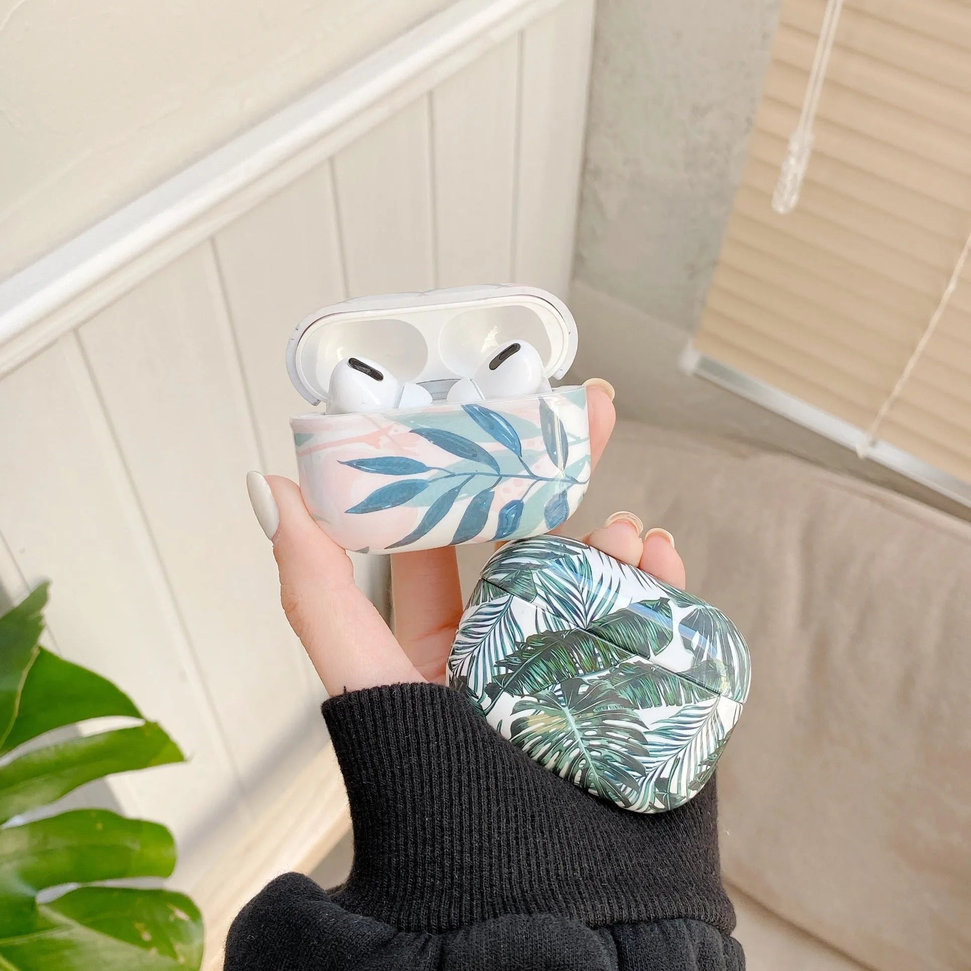 Blue and green banana leaves design soft TPU protective case for Apple AirPods.