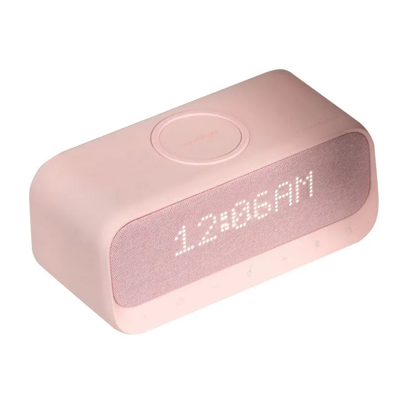 White Soundcore Bluetooth speaker with wireless charging top and digital display.